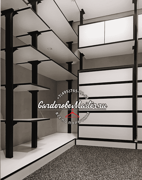 Фрагмент гардеробной Фрагмент гардеробной с многоуровневыми полками, чёрные стойки и белые поверхности, акцент на вертикальной модульности и гибкой настройке хранения